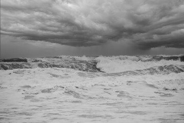 Let the storm rage on, stormy sky and large waves as heavy rain and storm hits Wales UK. A result of climate change and global warming storms are more frequent and very dangerous.