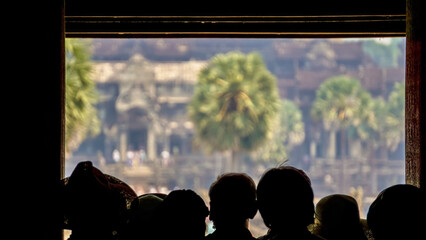 Cambodscha, Angkor wat statues and nature all around 
tourists admire the view 
tourist with a...