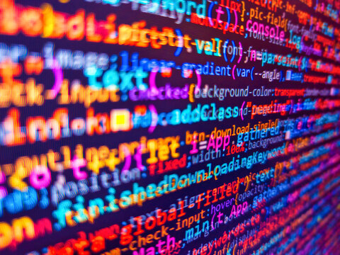 The colorful code on screen. Abstract modern virtual computer script. Computer html code on screen. Coding concept. Work of software developer programmer on desktop screen closeup. Pink color.