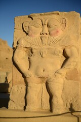 Fototapeta premium A curious being, Bes, Hathor gate, Dendara, Quena, Egypt, Africa. An ancient Egyptian God, the Egyptian people favoured an amulet in the home for protection of child birth and fertility.. 