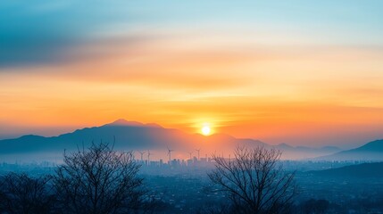 Obraz premium A breathtaking sunset over misty mountains, blending vibrant colors in the sky, perfect for nature and tranquility themes.