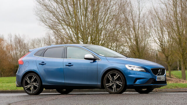 2016 blue Volvo V40 estate car driving on an English country road.