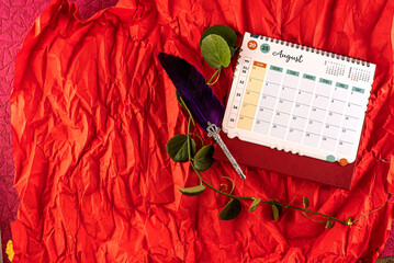 January 2025 desk calendar on red background. 