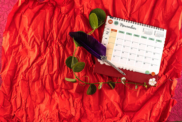 January 2025 desk calendar on red background. 