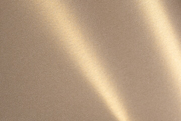 Luxurious paper background with a soft monochrome gradient in warm taupe and champagne tones. Smooth