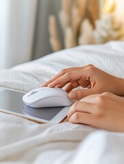 Fototapeta premium A person interacting with a tablet on a bed with a soft blanket and glowing fairy lights, symbolizing comfort and digital convenience