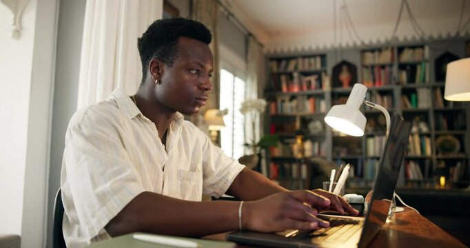 Learning, university student and typing on laptop in home for online research, masters thesis or proposal deadline. Scholarship, black man and writing feedback review for college assignment and study