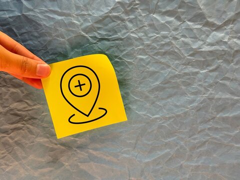 A hospital geolocation icon is painted on office paper. the location of the hospital on the map. medical care for people. a banner for advertising medicine for websites. medical care.