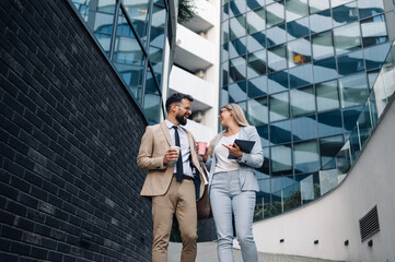 Business people walking and talking during coffee break
