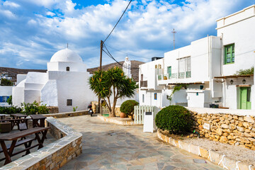 White church and typical traditional houses on street of Chora village, Folegandros island, Cyclades, Greece