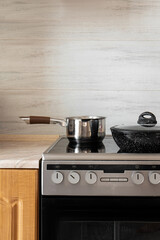 A saucepan stands on the hob in the kitchen