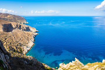 View of high rock cliffs and azure turquoise sea of from Chora village, Folegandros island,...