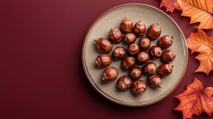 Chestnuts arranged in a star pattern on a ceramic plate, isolated on a deep burgundy background with holiday decor