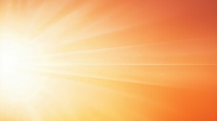 Obraz premium A radiant sunrise with soft orange hues and bright sun rays spreading across the sky, creating a warm and inviting atmosphere.