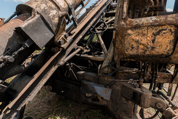 Rusty Excavator Components in a Lush Green Field