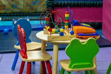 kids table and chairs with toys on top of the table