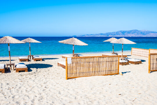 Sun umbrellas on stunning Plaka beach with crystal clear sea water, Naxos island, Cyclades, Greece
