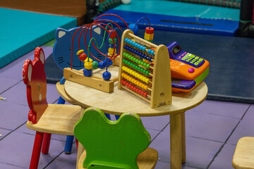 kids table and chairs with toys on top of the table