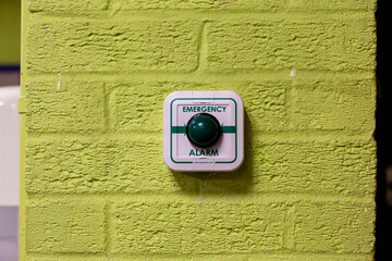 emergency alarm button on a green wall