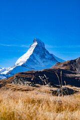 Autumn landscape of high alpine mountains in Switzerland with Matterhorn in the background