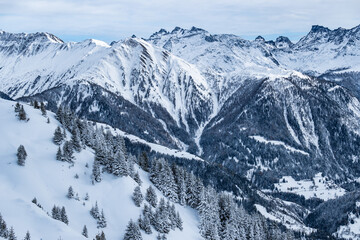 Fototapeta premium Winter snow landscape of a valley in the high alpine mountains of Switzerland