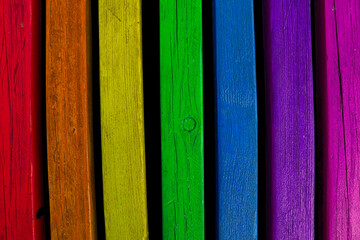 Old wooden planks with a natural texture painted in bright vibrant colors