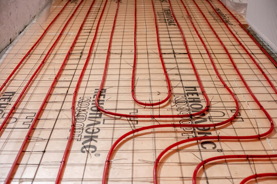 Installation of underfloor heating. Pipes for underfloor heating made of cross-linked polyethylene are attached to a reinforced mesh lying on polyurethane foam penoplex. Russia, Anapa - 08.06.2024
