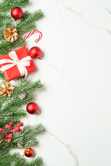 Christmas flat lay background on white. Christmas ornaments, present box and decorations.