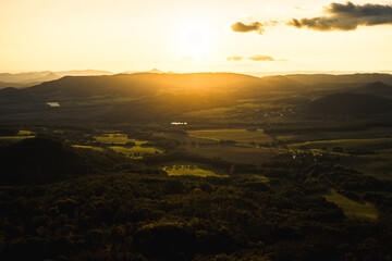 A stunning sunset over a valley with the sun shining through clouds