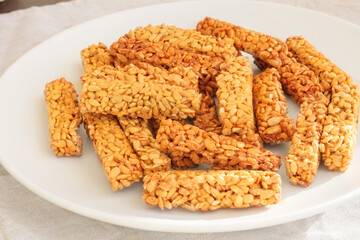 Gozinaki in a ceramic plate. Sweet granola in plate for holiday. Homemade seed sunflower candies.