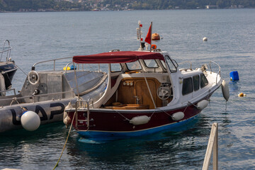 Obraz premium Classic Wooden Motorboat Moored in a Coastal Marina