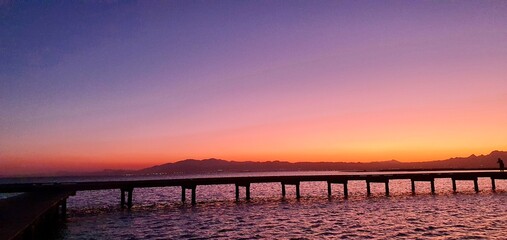 Sunset with beautiful colors by the sea and marina
