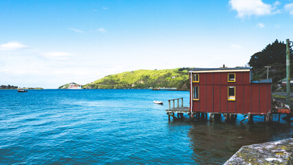 Boat house jetty bridge otago peninsula new zealand dunedin clear day blue ocean
