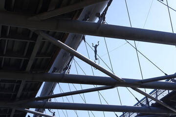 Figure in a metal cable in a bridge