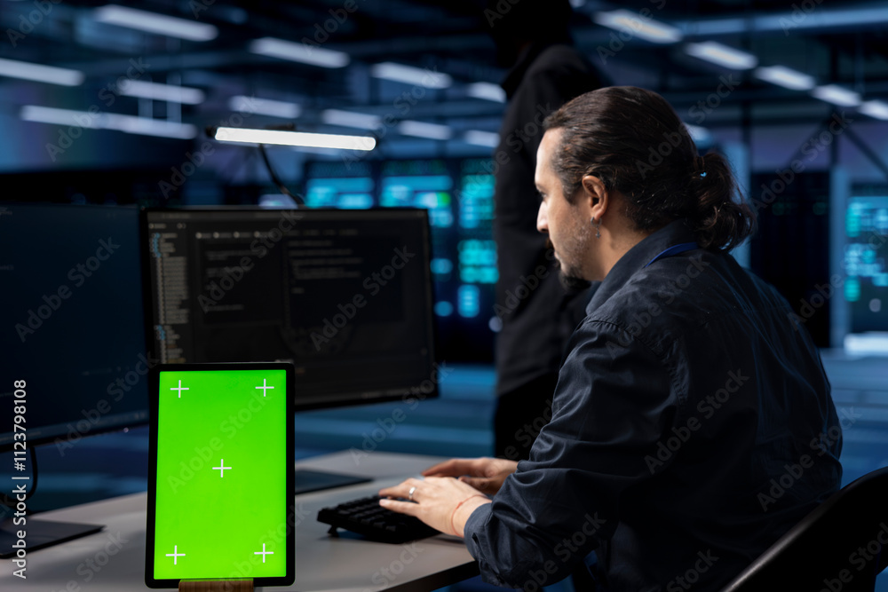 Poster engineer in server hub ensuring data remains shielded from potential threats using isolated screen t