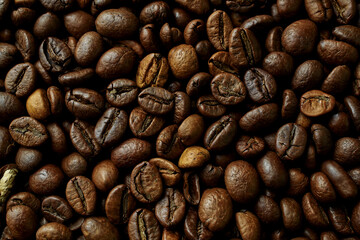 Fototapeta premium Coffee beans close-up roasted brown texture background aromatic caffeine beverage ingredient macro photography high resolution food and drink concept