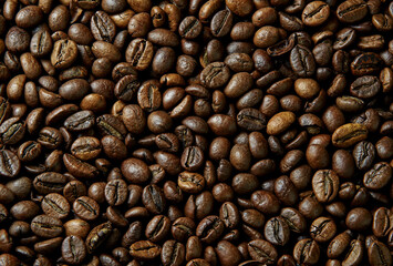 Coffee beans close-up roasted brown texture background aromatic caffeine beverage ingredient macro...