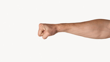 Millennial man clenching fist on light grey background, closeup. Copy space. Panorama
