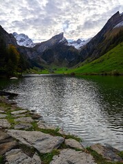A clear lake in a swiss alp mountain during a cloudy evening in september