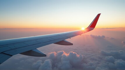 Fototapeta premium Airplane Wing at Sunset Above the Clouds in Vibrant Sky Colors