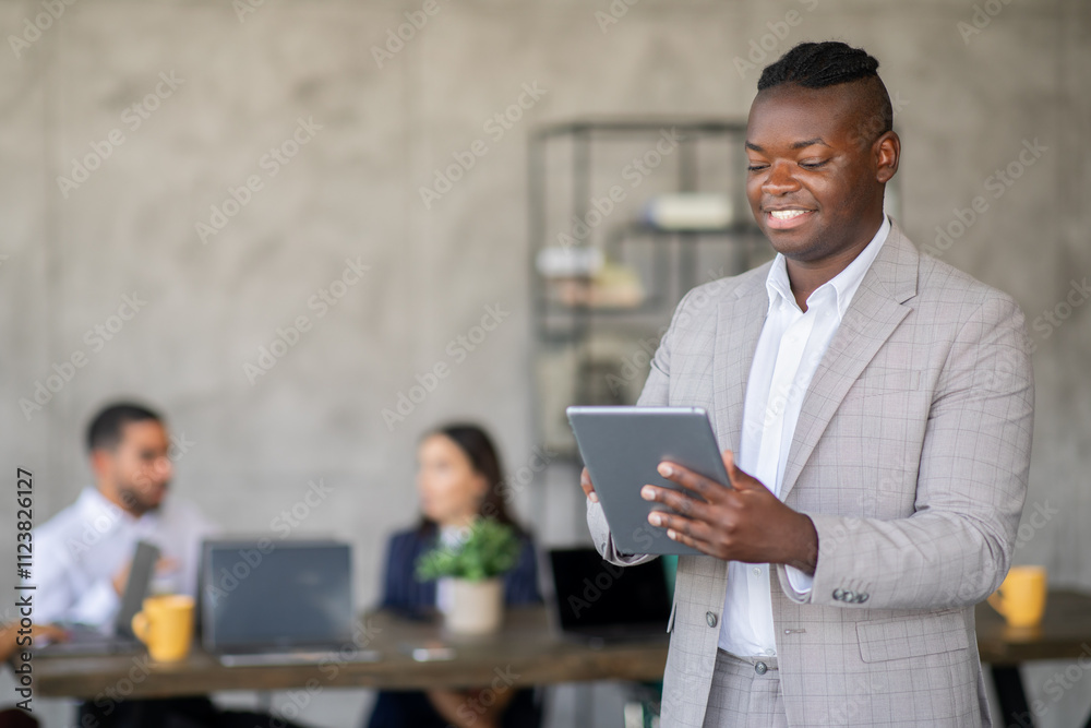 Poster a diverse team works together in a sleek office, with one member engaging on a tablet while others d