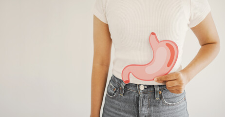 woman hands holding stomach, heartburn, Gastroesophageal reflux disease (GERD) or acid reflux...