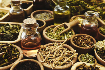 Essential oil bottles and medicinal herbs background, alternative medicine background, selective focus, shallow DOF