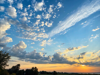 Obraz premium sunset in the sky. sunset, sky, clouds, sun, cloud, landscape, sunrise, evening, orange, nature, blue, trees, light, dusk, summer, beautiful, yellow, red, time lapse, silhouette