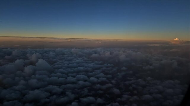 Looking down on clouds showing a mountain 