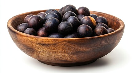 Obraz premium A wooden bowl filled with dark-purple acai berries isolated on a white background.