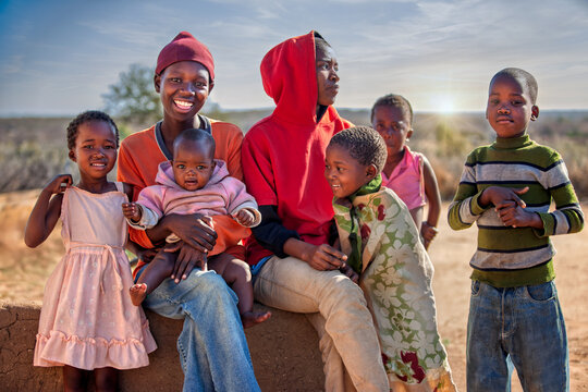 NGO volunteer charity organizations helping people to have a healthy better life. Africa village, large african family, children and teenagers