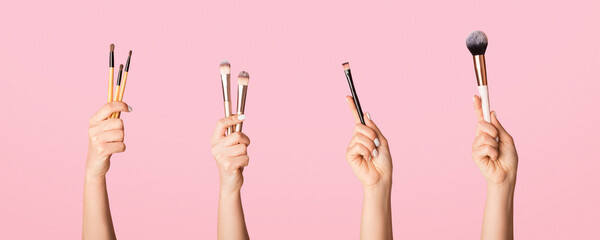Fototapeta premium Various makeup brushes in female hands on pink background, closeup view. Collage. Panorama