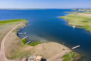 A beautiful lake with a lot of boats and a small cabin