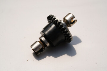 Closeup Remote Control Car Differential Gear isolated on white. Metal Gear parts allowing the...